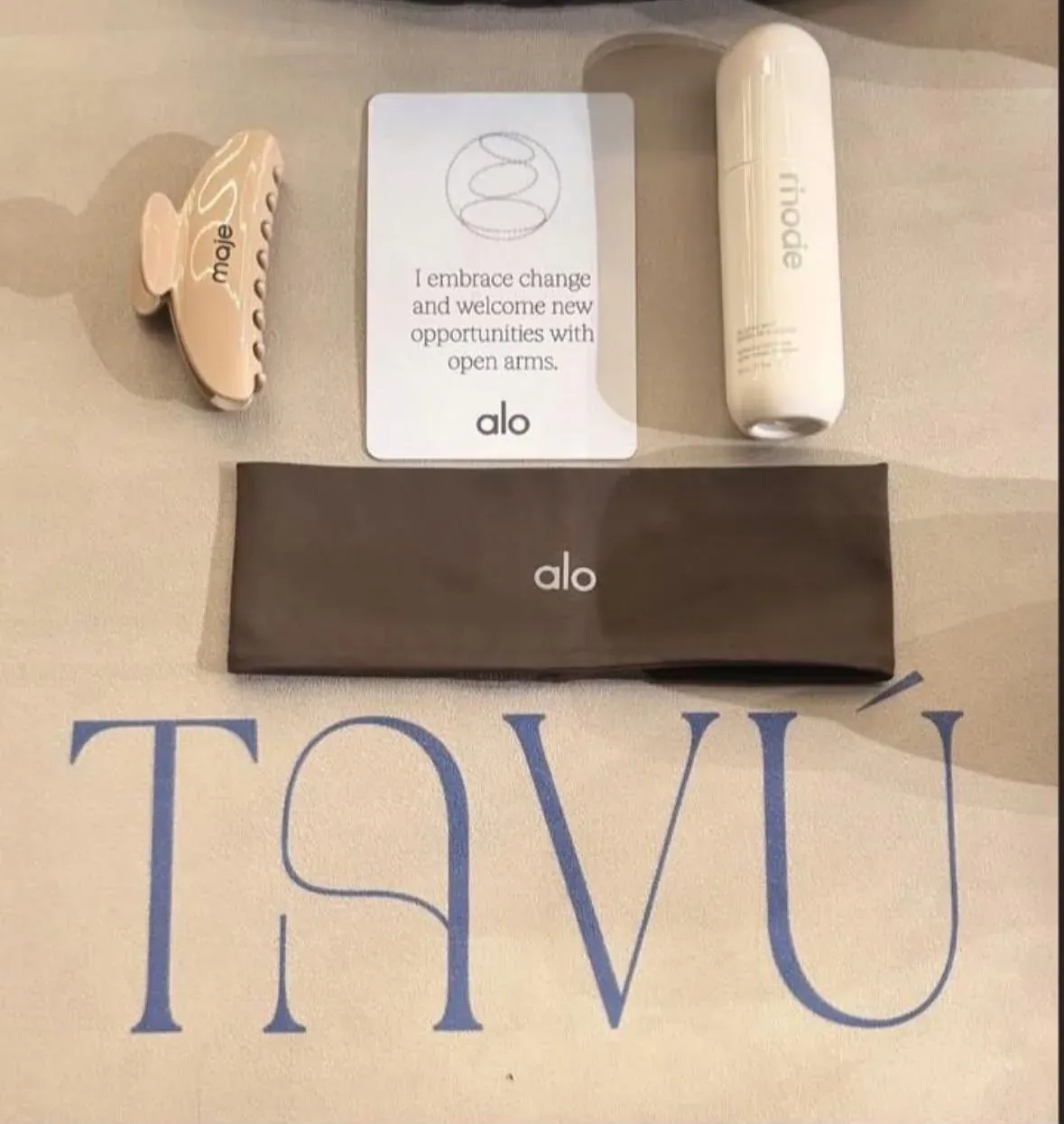 ALO + TAVÚ collaboration — ALO gifts laid out on a TAVÚ mat