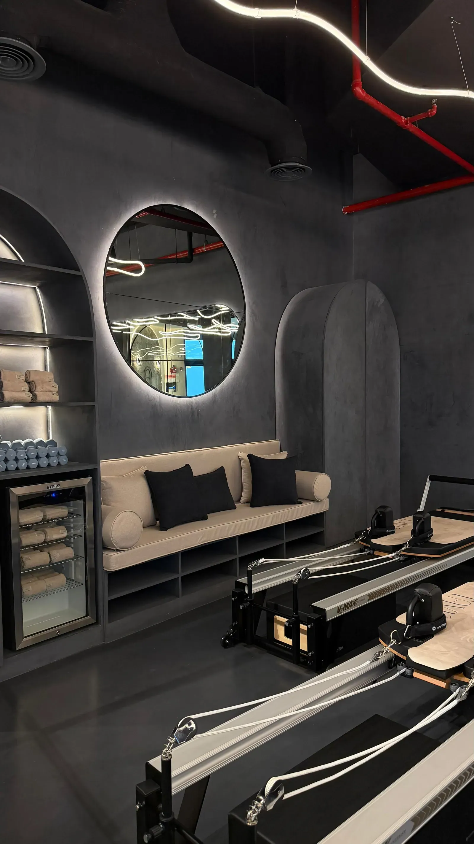 TAVÚ Reformer Pilates studio with circular backlit mirror